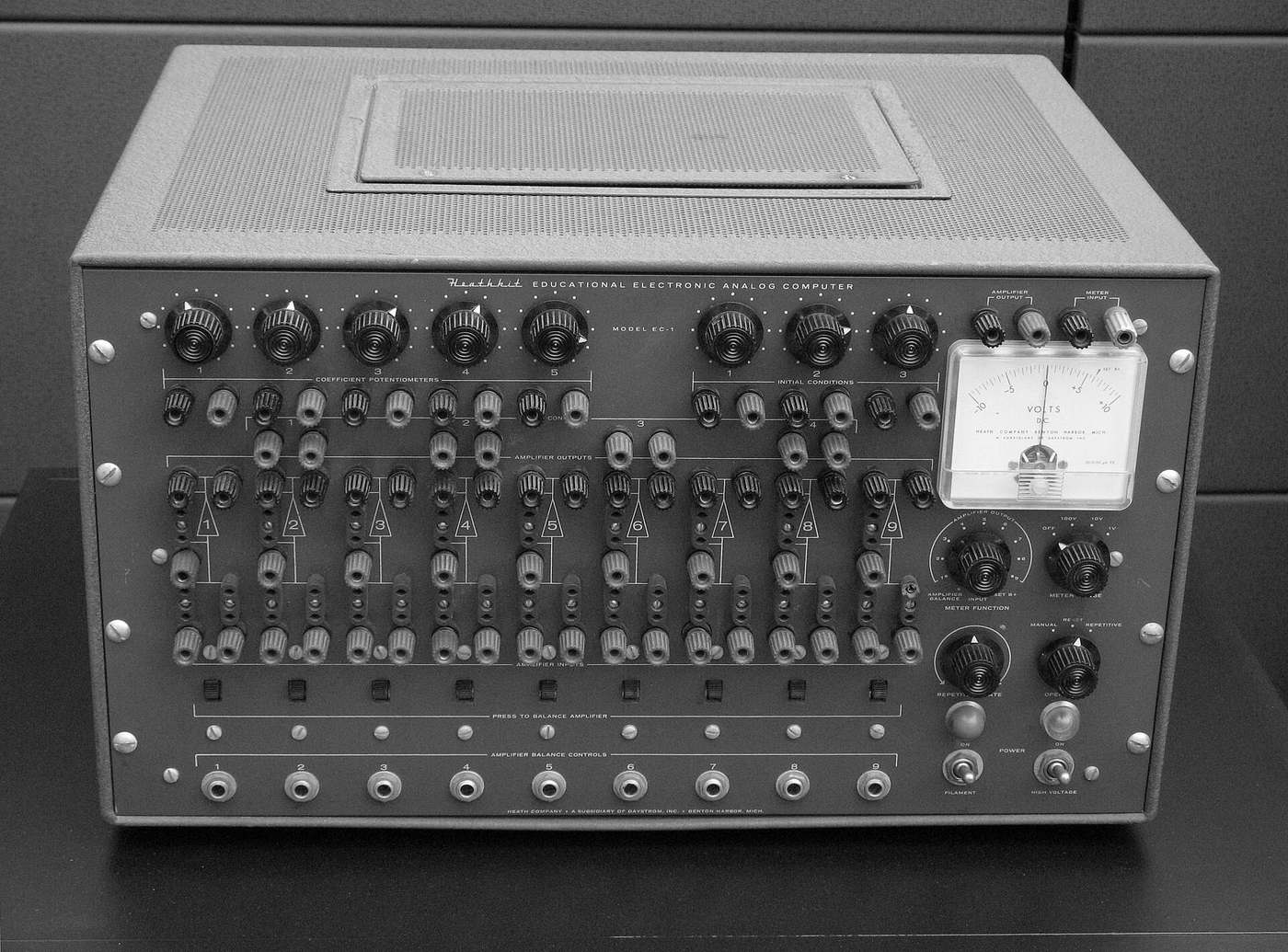 The front panel of a Heathkit EC-1 educational analog computer: rows of coefficient potentiometers, red and black patch sockets, and a voltmeter.
